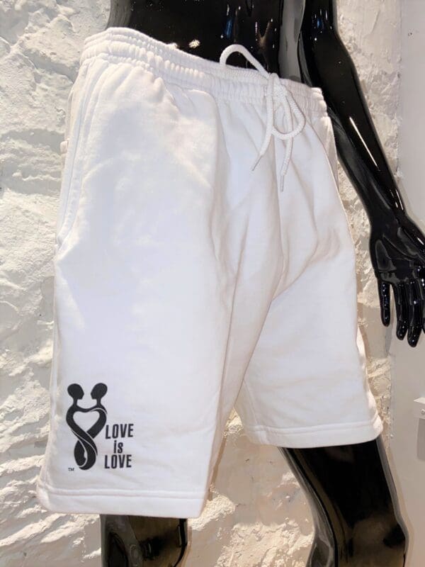 A pair of white shorts with the words love life on it.