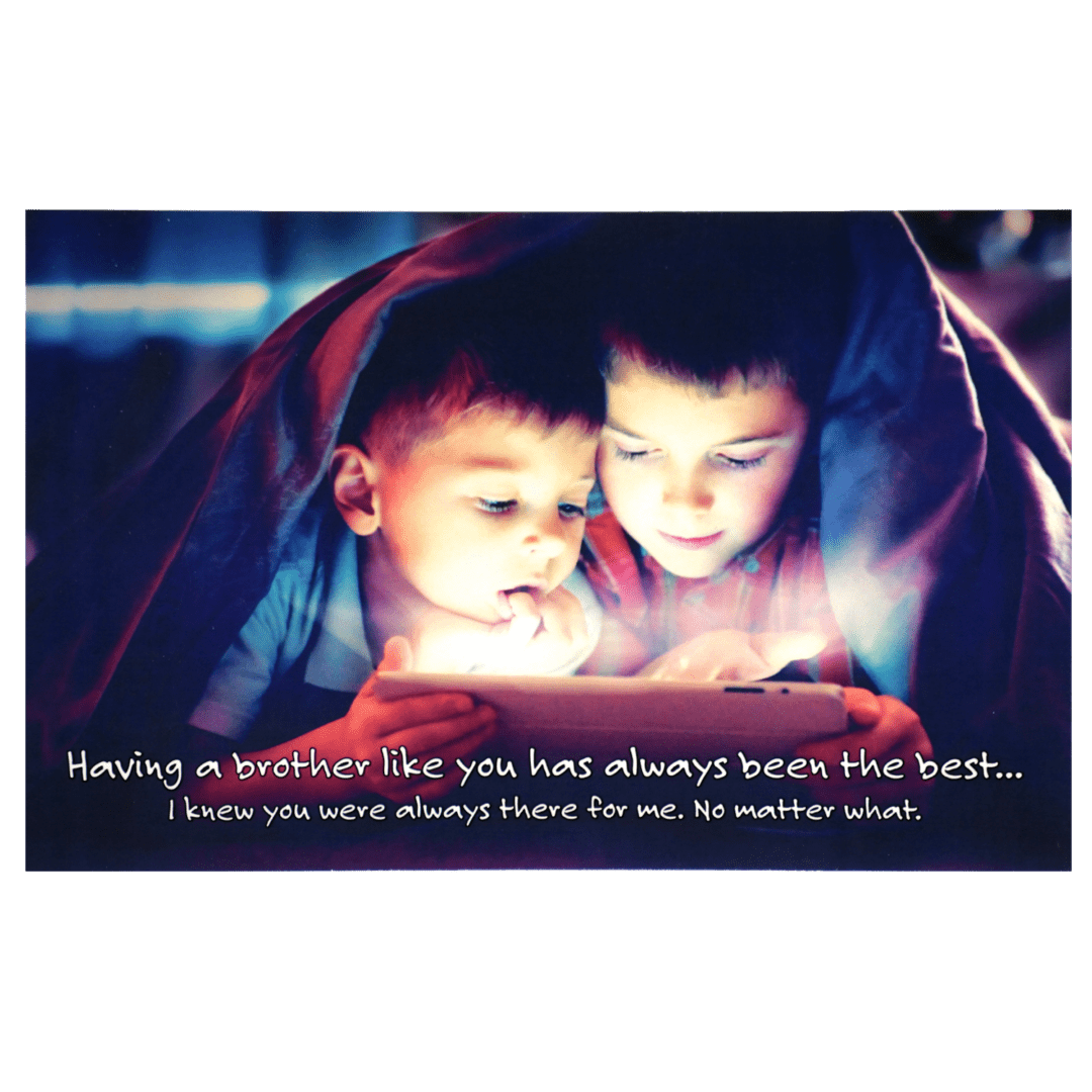 Two children under a blanket looking at an ipad.