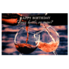 A person pouring wine into a glass with the words " happy birthday our bottle, or more ?" on it.