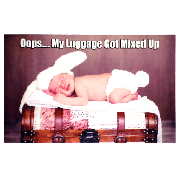 A baby laying on top of a suitcase.