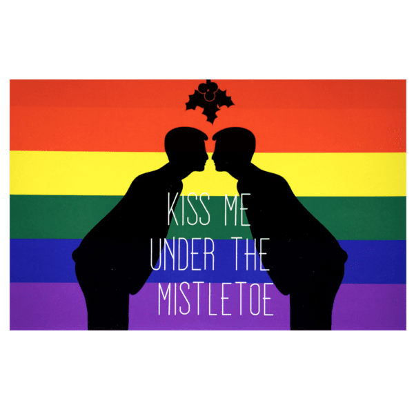 A couple of men kissing in front of the rainbow flag.