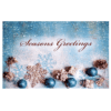 A christmas card with blue ornaments and snow flakes.