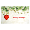 A red heart hanging from a christmas tree.