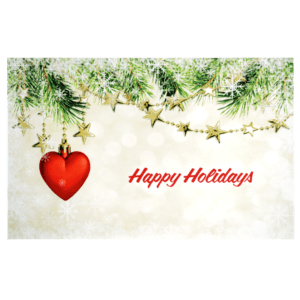 A red heart hanging from a christmas tree.