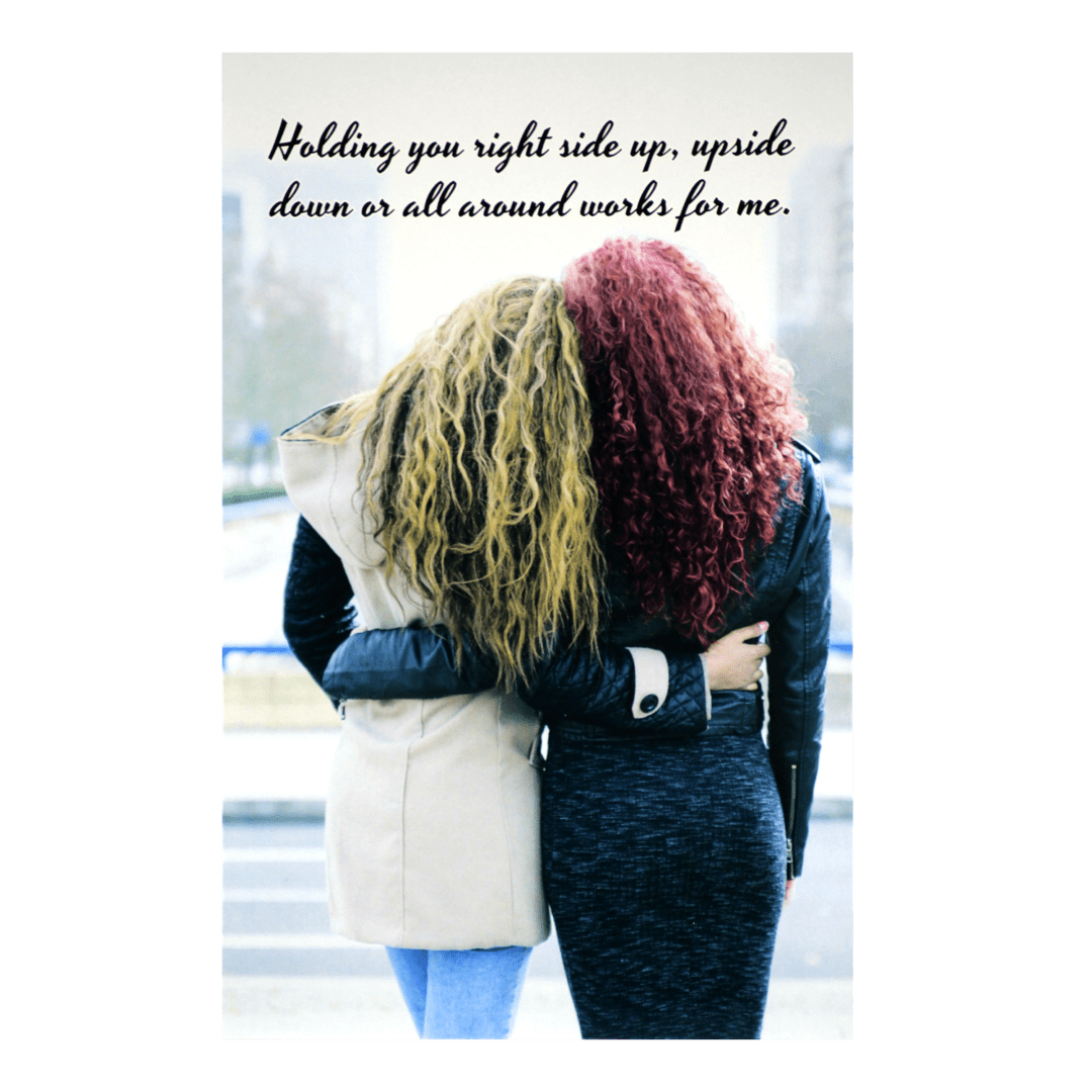 Two women standing next to each other on a sidewalk.