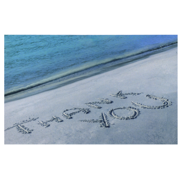 A beach with sand writing in the sand