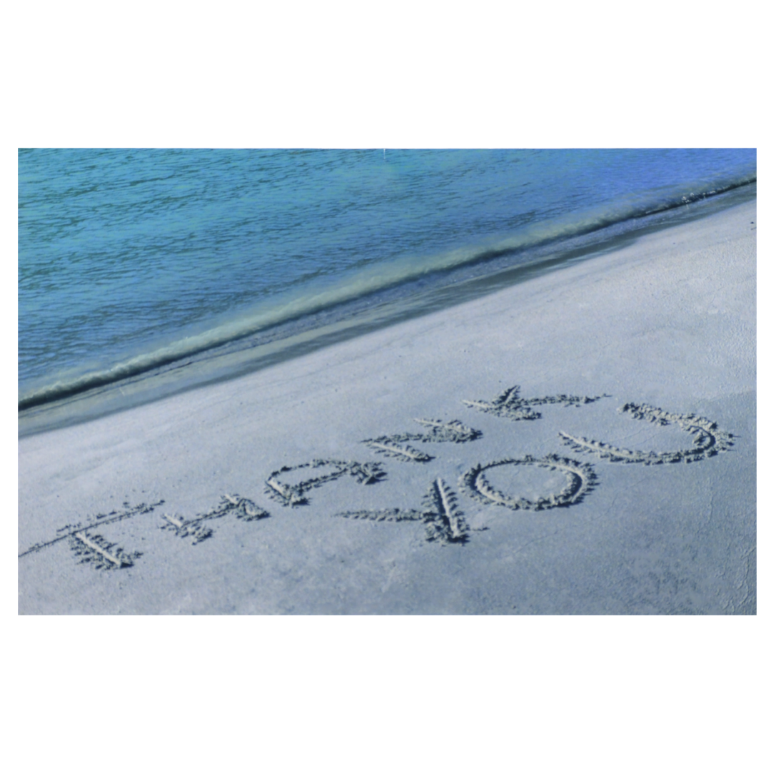 A beach with sand writing in the sand