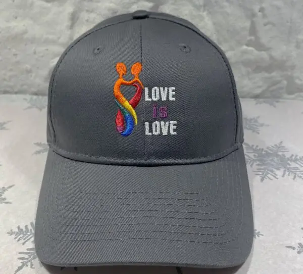 A gray hat with the words " love is love ".