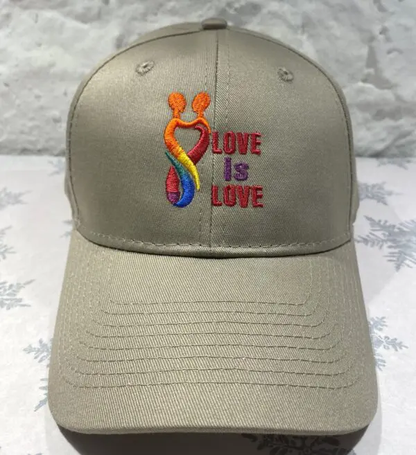 A baseball cap with the words love is love embroidered on it.