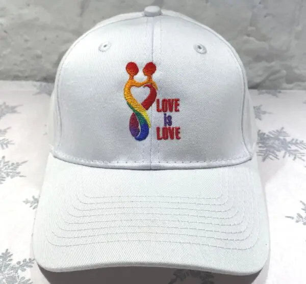 A white hat with the words love is love on it.