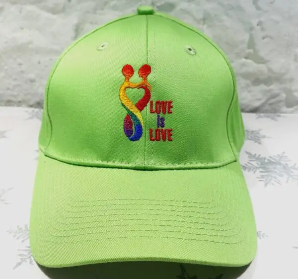 A lime green hat with the words " love is love ".