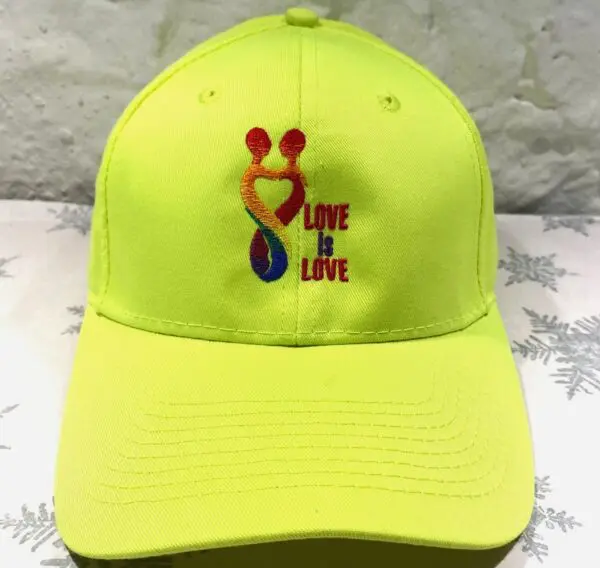 A neon yellow hat with the words " love is love ".