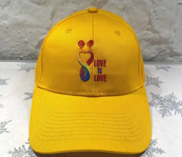 A yellow hat with the words " love is gone ".