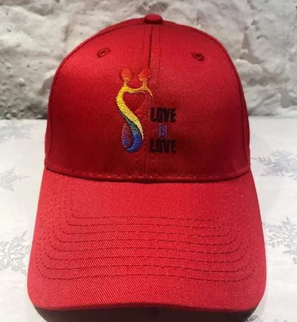 A red hat with the words " love is love ".