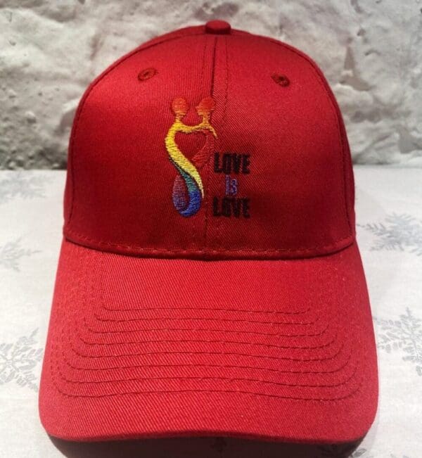 A red hat with the words " love is love ".