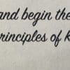 A close up of the words and begin the principles of karma