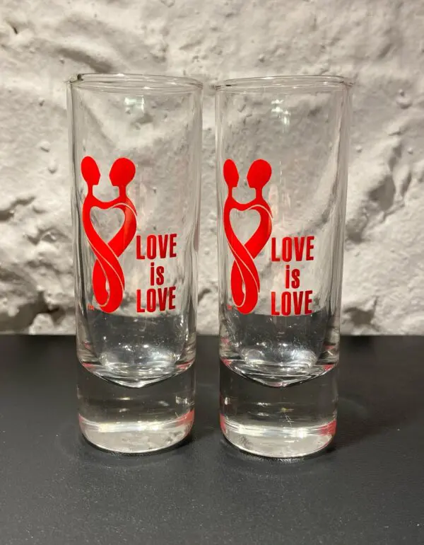 Two glasses with the words love is love on them.