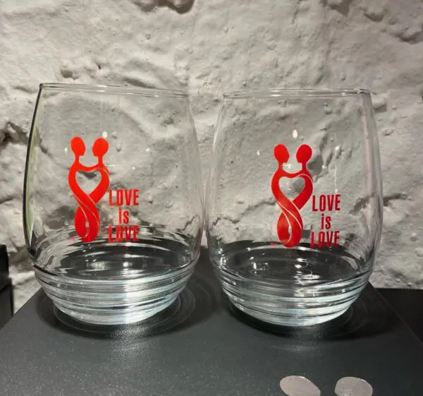 Two glasses with a mickey mouse design on them.