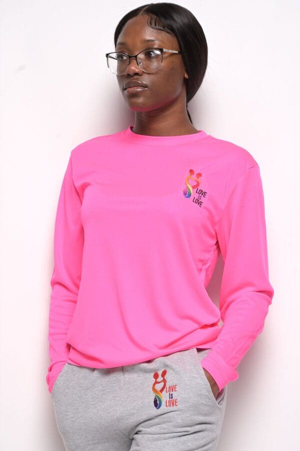 A woman wearing a pink long sleeve shirt.