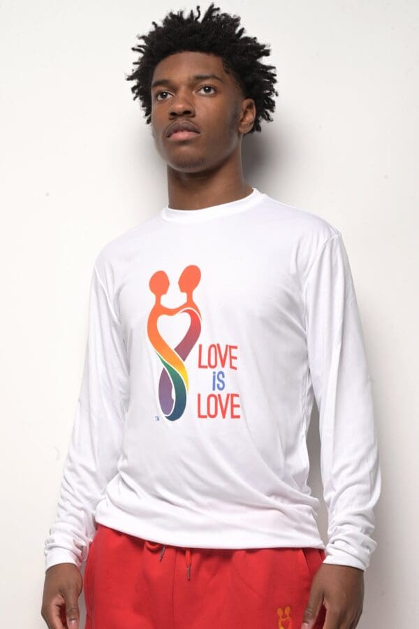 A man wearing a white shirt with the words " love is love ".