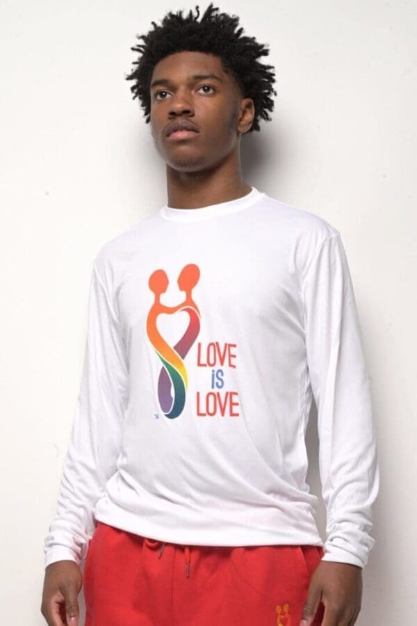 A man wearing a white shirt with the words " love is love ".