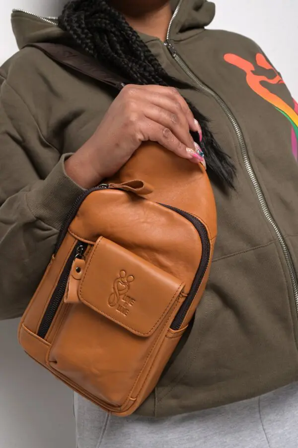 A person holding onto a brown bag