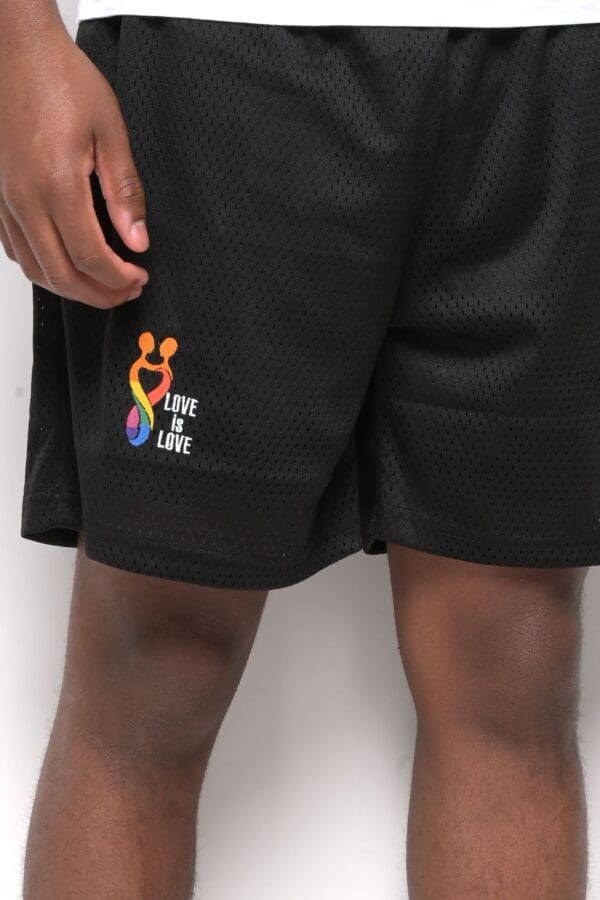 A person wearing black shorts with the words " live life " on them.