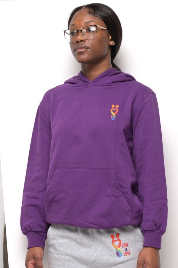 A person wearing a purple hoodie with a logo on it.