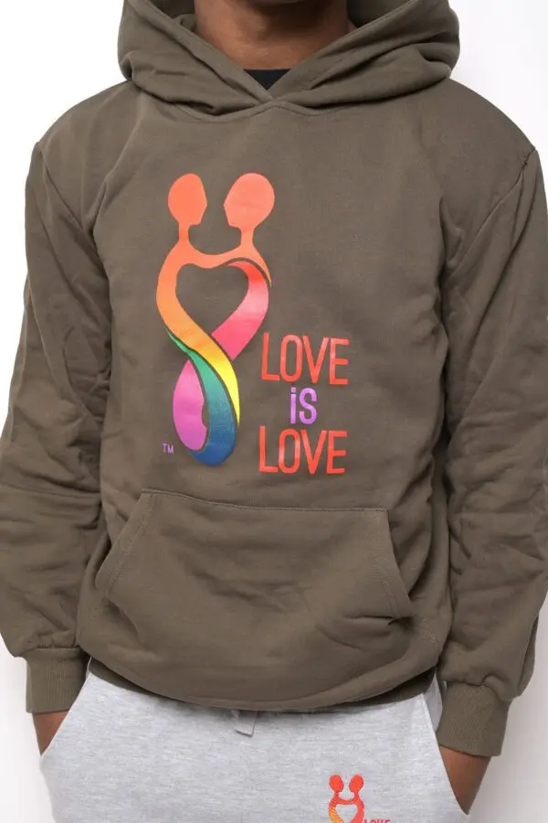 A person wearing a hoodie with the words love is love on it.