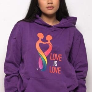 A woman wearing a purple hoodie with the words 