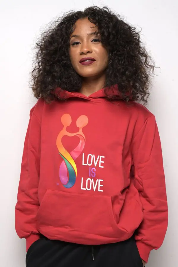 A woman wearing a red hoodie with the words " love is love ".