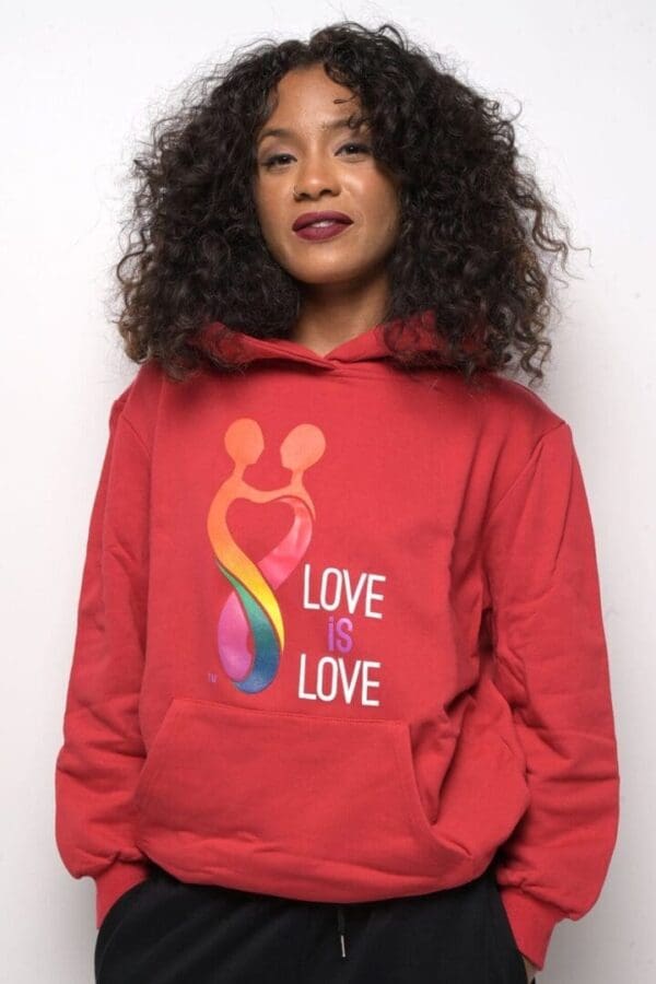 A woman wearing a red hoodie with the words " love is love ".