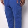 A person wearing blue pants and orange shoes.