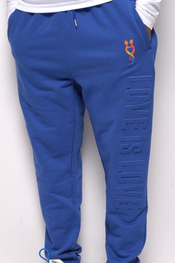 A blue sweat pants with the words " queens court ".