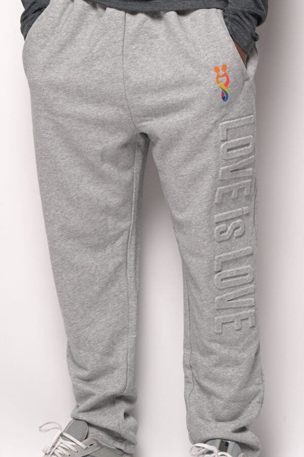 A pair of grey pants with the words " love is love ".