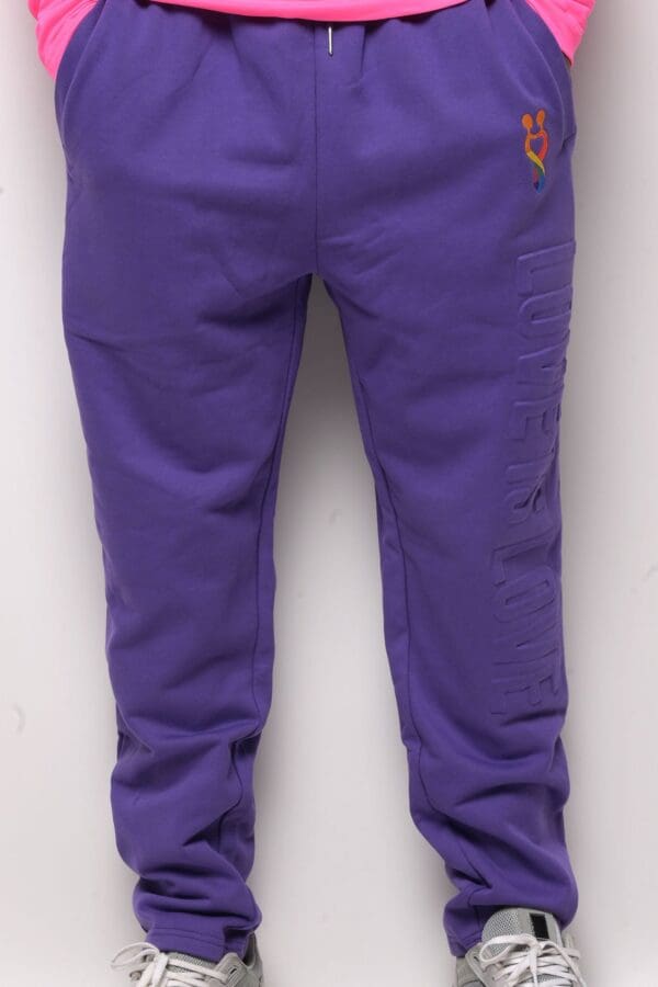 A purple pair of pants hanging on the wall.