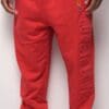A person wearing red pants and a white shirt