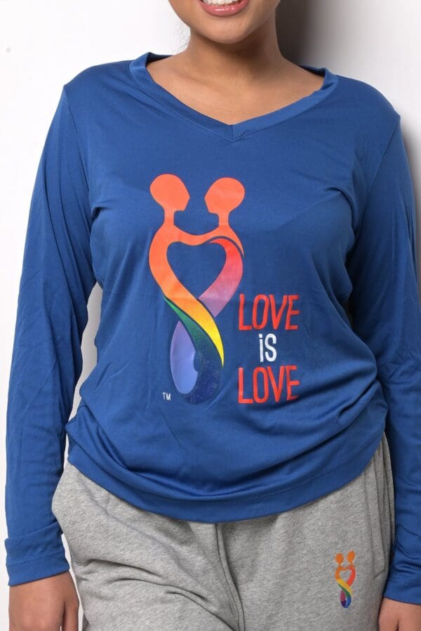 A woman wearing a blue shirt with the words " love is love ".