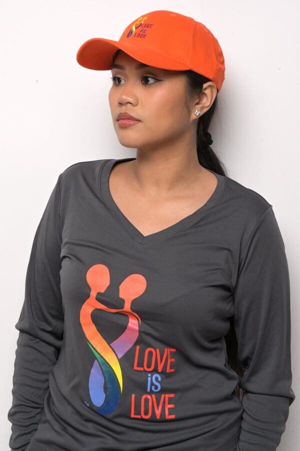 A woman wearing a long sleeve shirt with the word love on it.