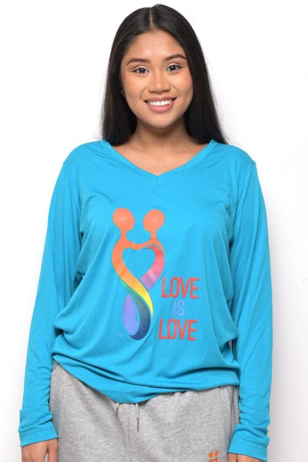 A woman wearing a blue shirt with the words love and care on it.