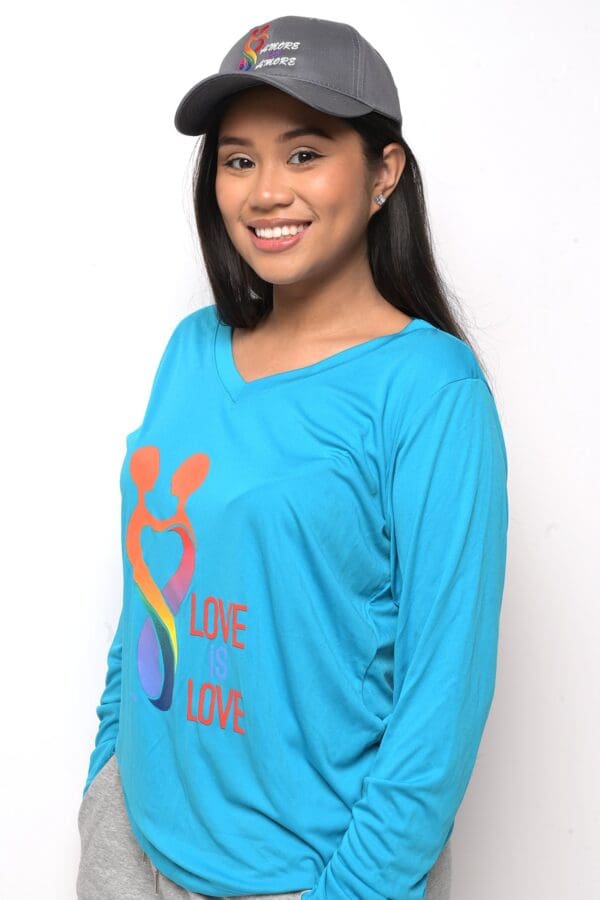 A woman in blue shirt smiling for the camera.