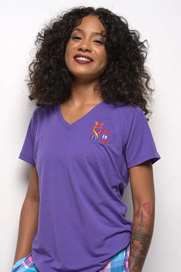 A woman wearing purple shirt with red and blue logo.