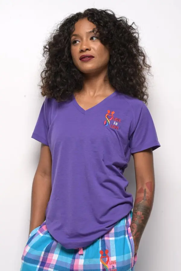 A woman wearing purple shirt and blue shorts