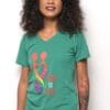 A woman wearing a green shirt with the words " love is life ".