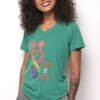 A woman wearing a green shirt with the words " love is love ".