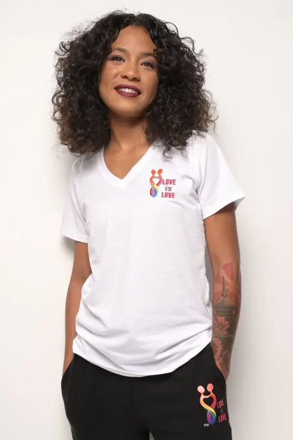 A woman wearing a white shirt with a cross on it.