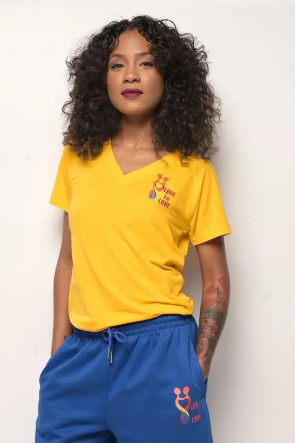 A woman wearing blue shorts and yellow shirt.