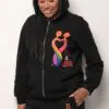 A woman wearing a black hoodie and holding her phone.