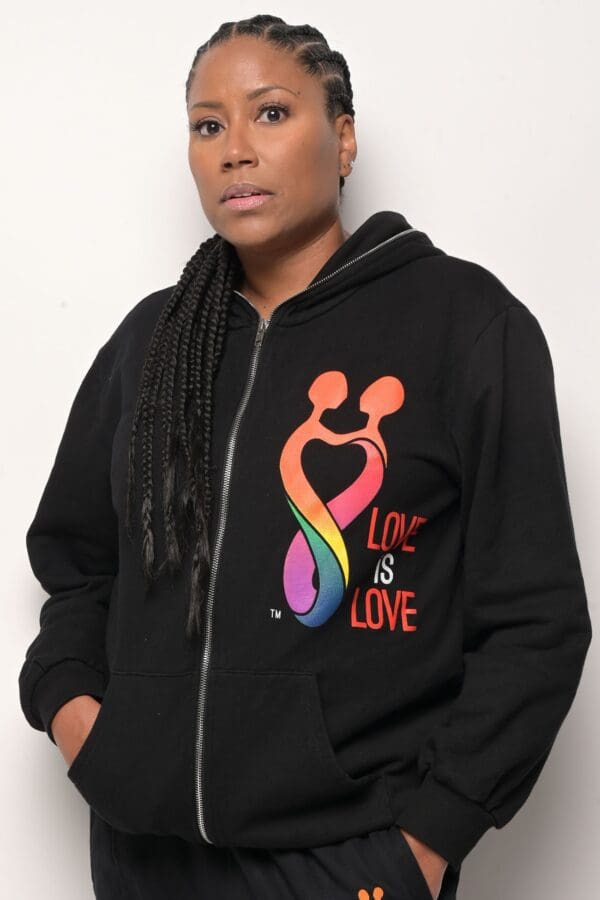 A woman with dreadlocks wearing a black hoodie.