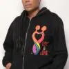 A woman with dreadlocks wearing a black hoodie.